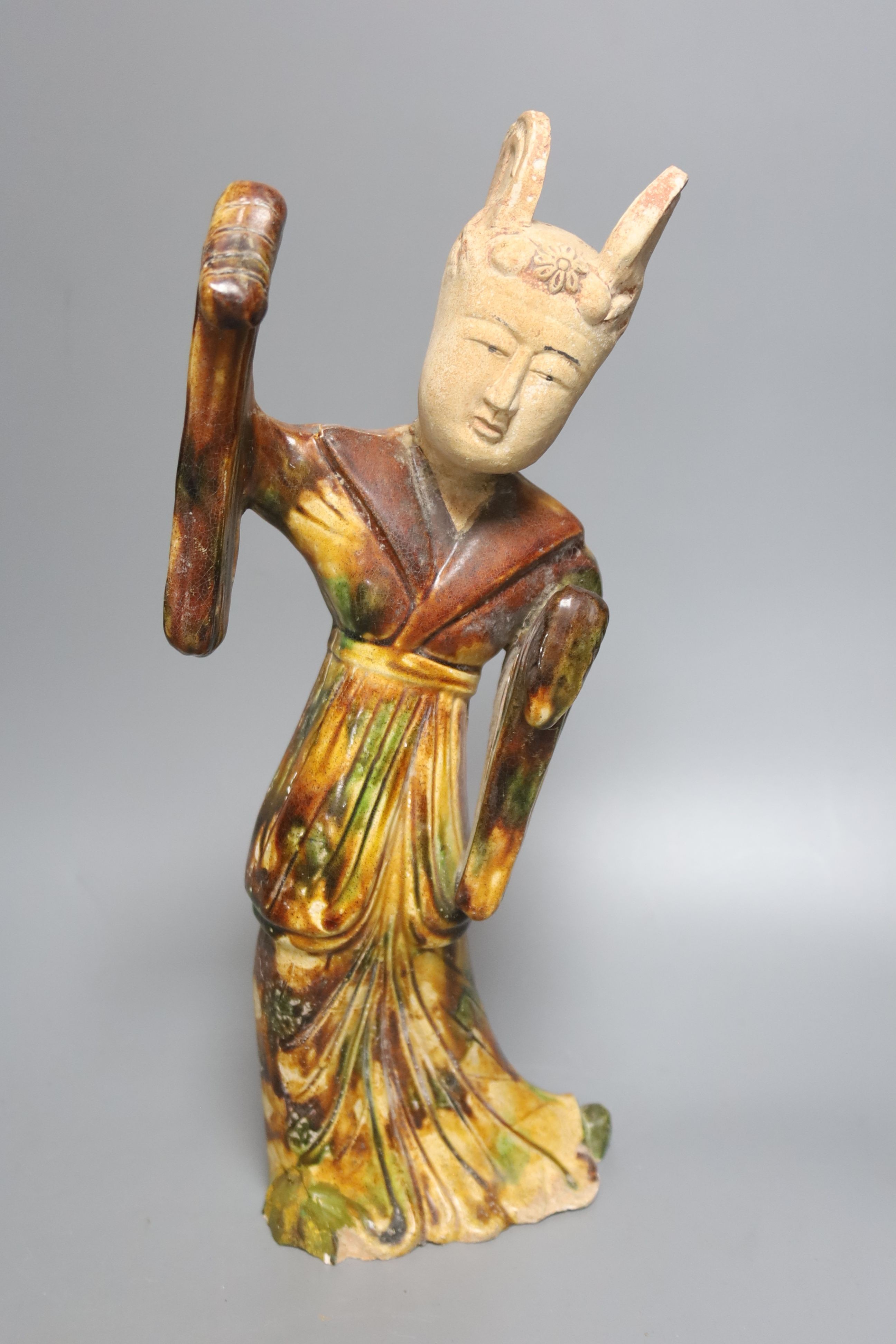 A Chinese Tang style sancai figure of a lady, a similar phoenix head ewer, a Yue type oil lamp and another vessel (4)